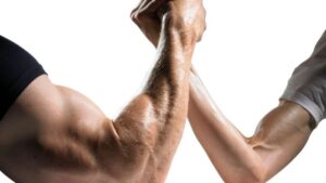 strong man arm wrestling a weak man