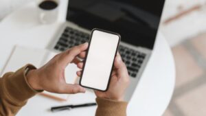 Man holding a phone | attention economy
