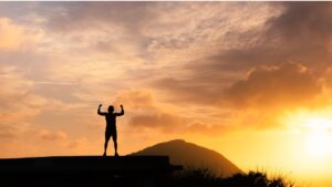 man standing on a mountain | how to be assertive