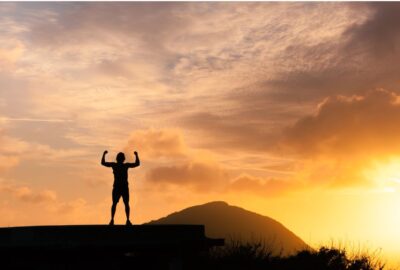 man standing on a mountain | how to be assertive
