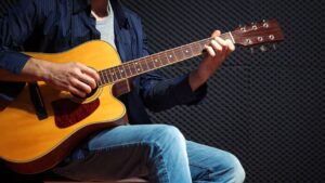 man playing guitar | power of consistency