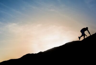 man climbing a mountain | plain jane