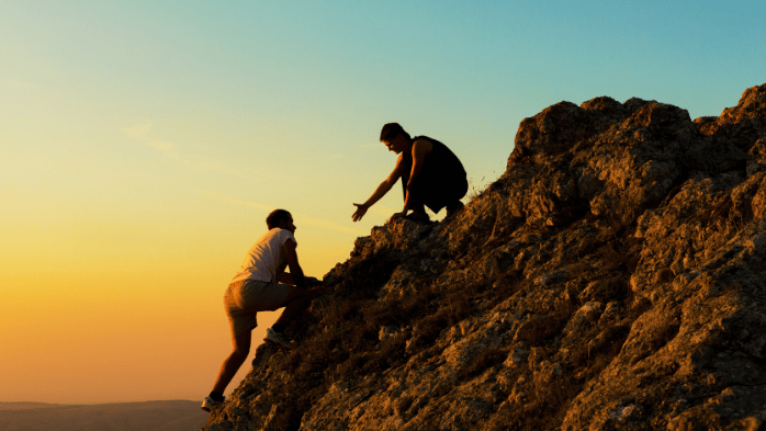 man climbing up a mountain | discipline vs. motivation