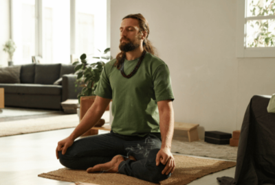 Man meditating and sitting down practicing wu-wei