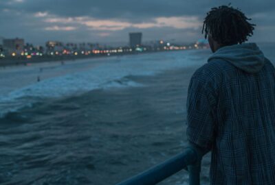 Man standing looking out over ocean