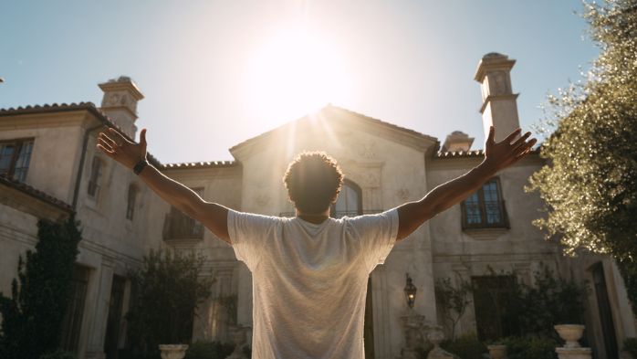 man standing outside arms stretched | the benefits of life architecture