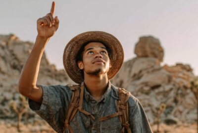 Young man pointing to the sky in Joshua Tree | Time Wasters